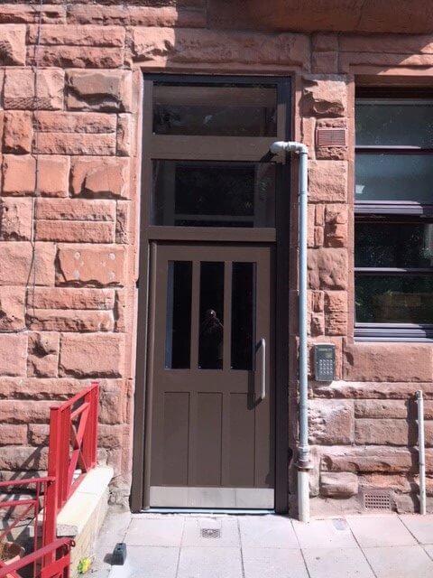 Brown communal steel door for flats.
