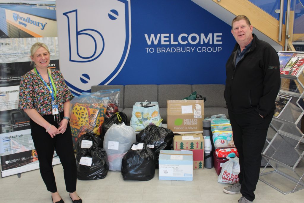 Aimee Burman HR & Payroll Coordinator handing over Ukraine donations and supplies which have been donated by Bradbury Group, and Ian Lawrence of the Lincolnshire Airsoft Club who will see that the goods are transported to the border of Ukraine and Poland.