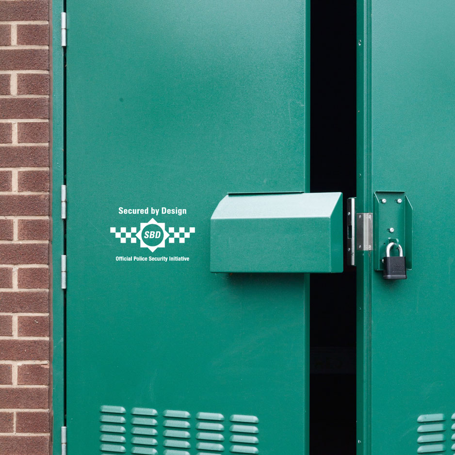 Green door with the Secured By Design logo on it.