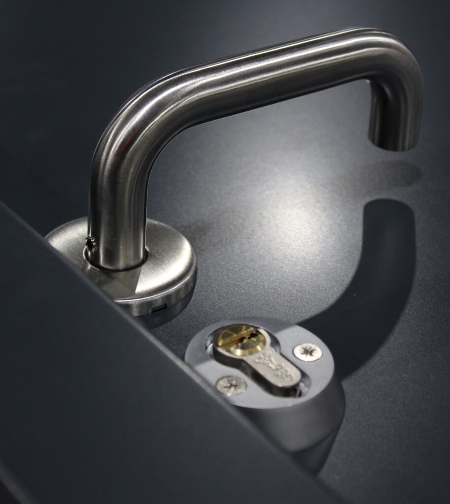 Metal door handle with a keyhole underneath it.